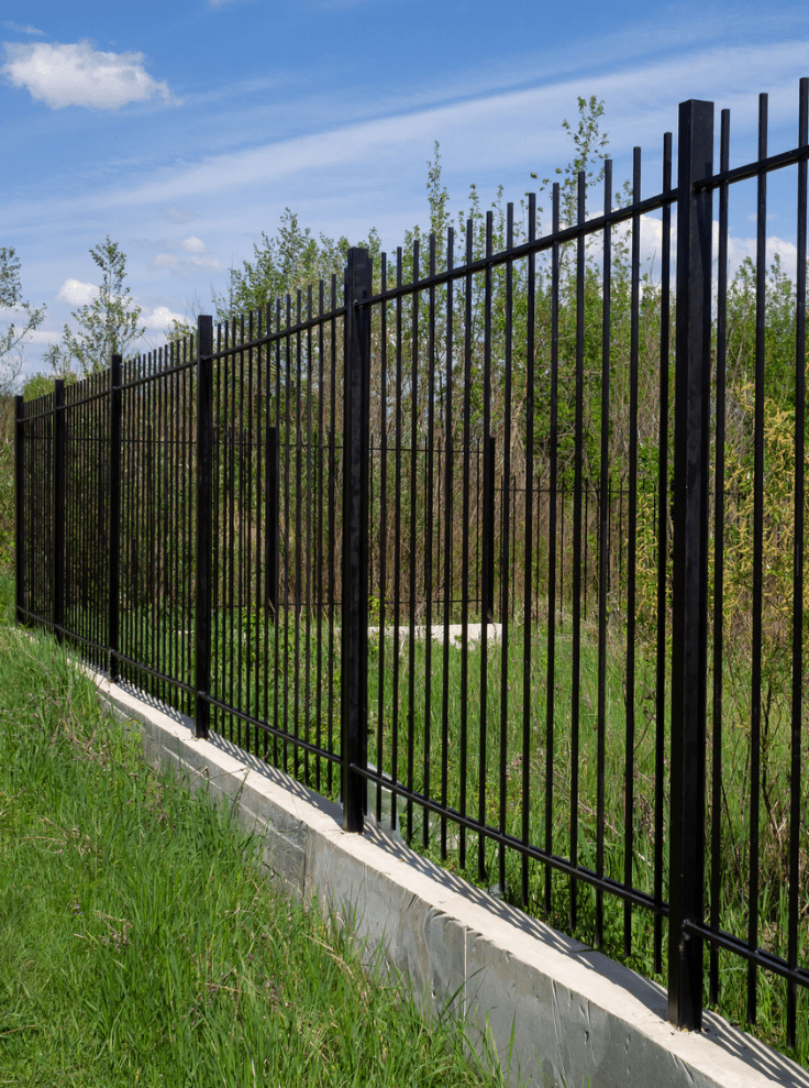 fence on top of concrete retaining wall
